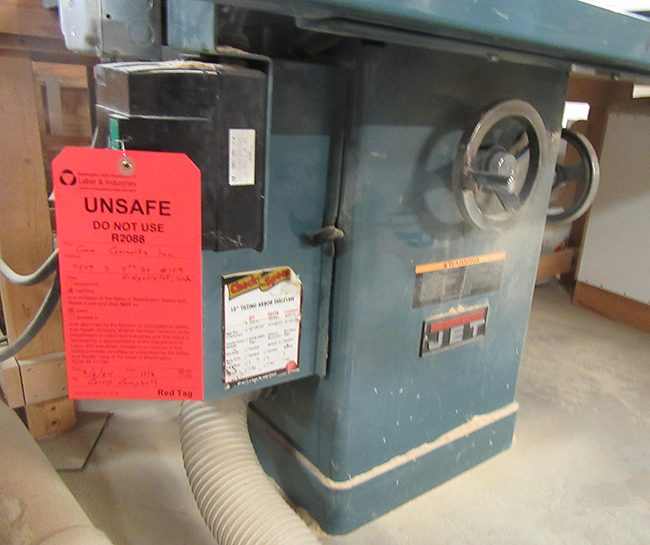 L&I inspectors posted red tags, like this one on a table saw, to ensure the equipment is not used until the hazards are fixed.