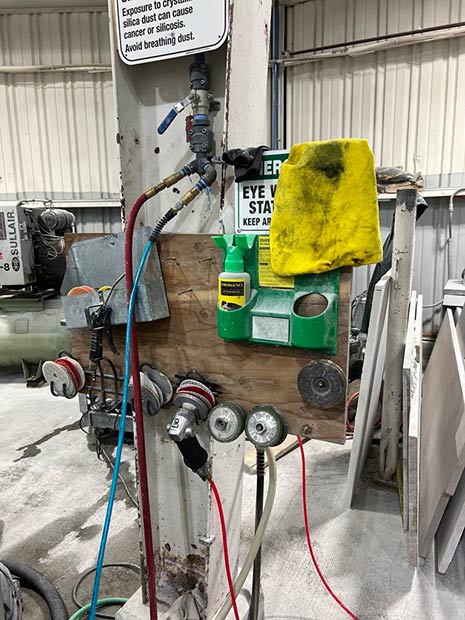 L&I photo shows the same rotary wet polisher cited for violations during April 2022 inspection with no changes made in recent inspection.