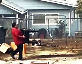 Juan P. Delgado carries a 48-lb table while prepping houses for sale