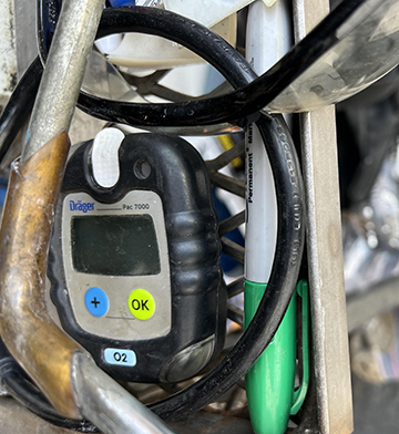 The deceased worker's oxygen monitor was found outside the controlled atmosphere room.